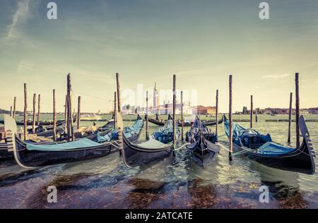 Berth with gondolas near Saint Mark`s Square in Venice, Italy. The gondola is a traditional romantic transport in Venice. Stock Photo